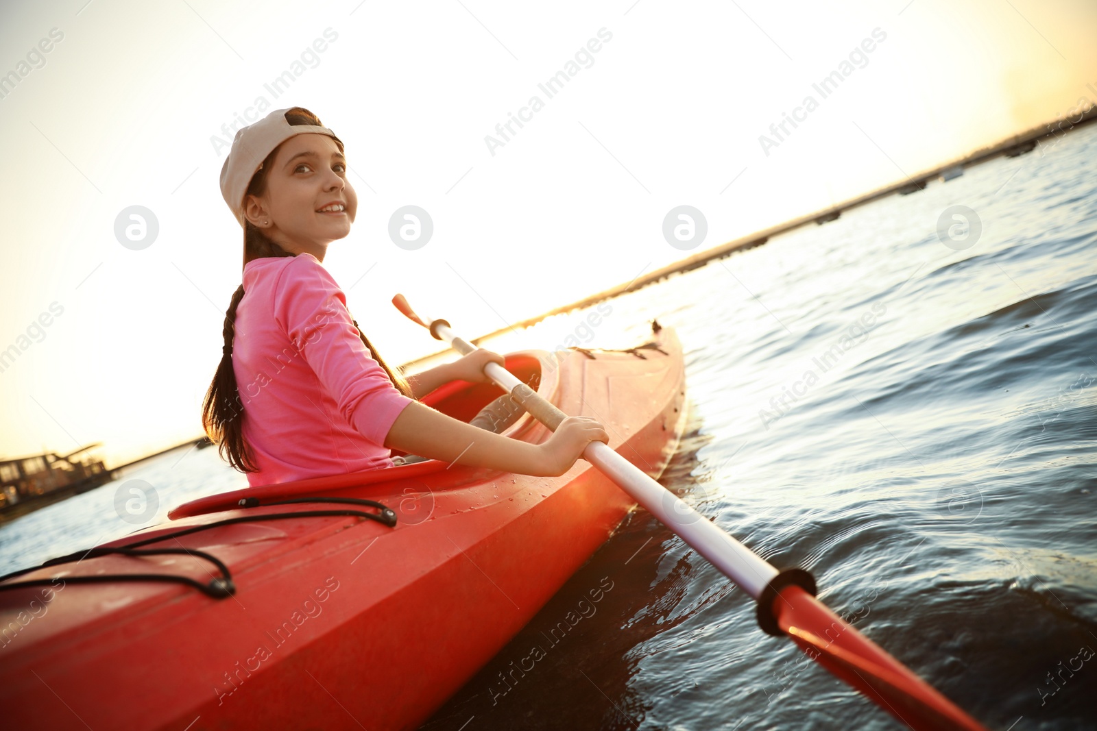 Photo of Happy girl kayaking on river. Summer camp activity