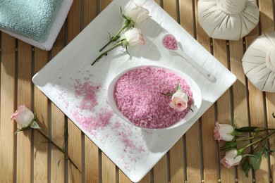 Flat lay composition with pink sea salt on wooden table