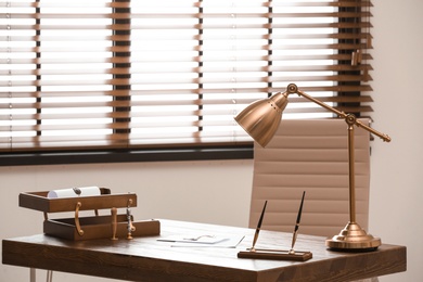 Photo of Notary's office interior with stationery and documents on desk. Space for text