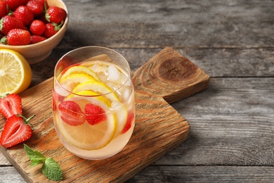 Natural lemonade with strawberries in glass on table