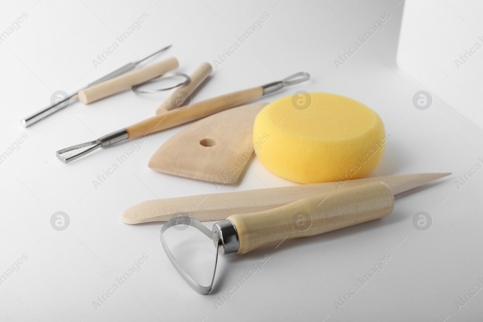 Photo of Set of clay modeling tools on white background