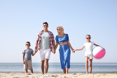 Happy family at beach on sunny summer day