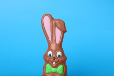 Chocolate bunny on light blue background. Easter celebration