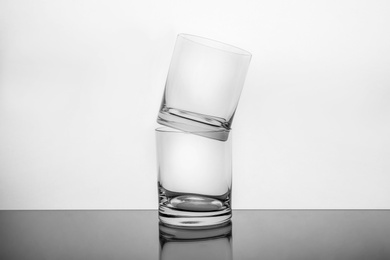 Photo of Stack of empty whiskey glasses on white background