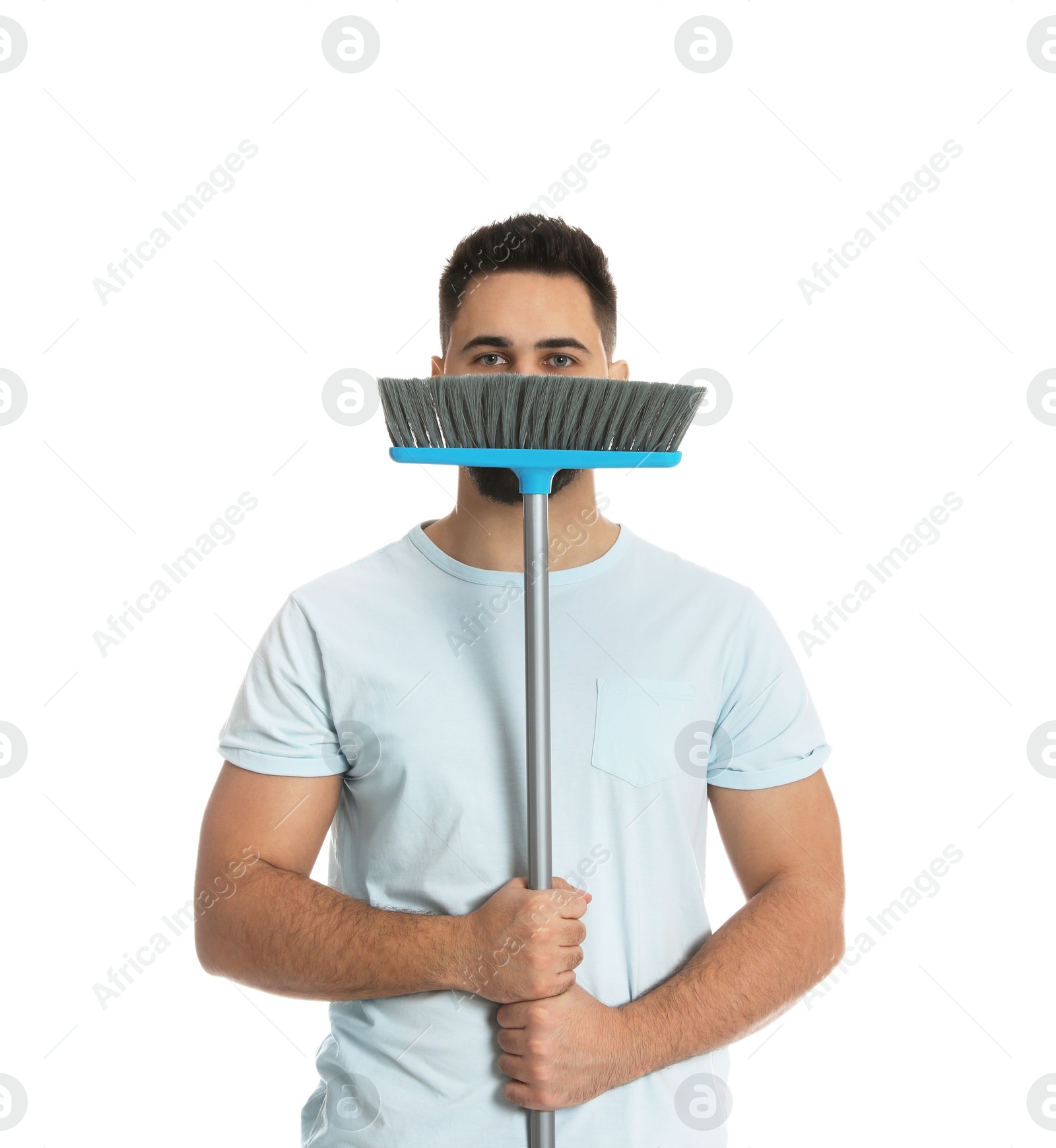 Photo of Young man with broom on white background