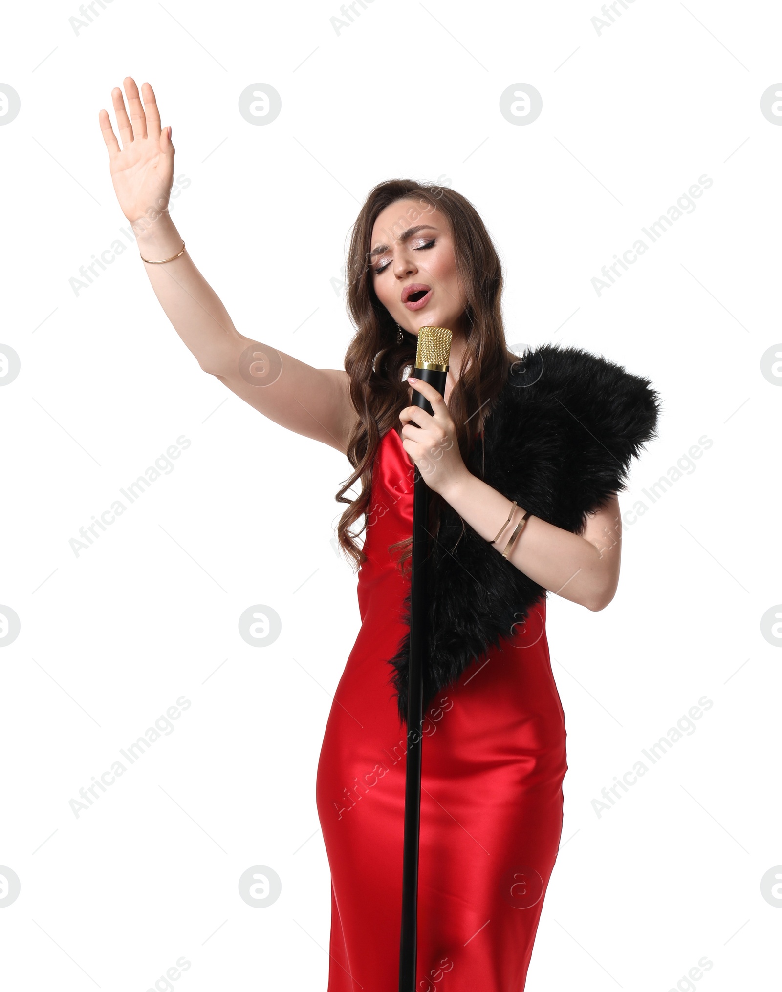 Photo of Beautiful young woman in stylish red dress with microphone singing on white background