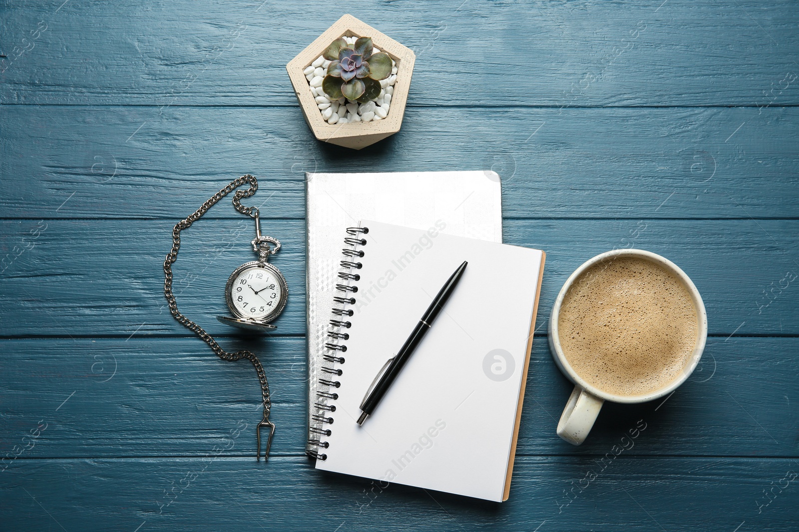 Photo of Flat lay composition with office stationery and cup of coffee on blue wooden table