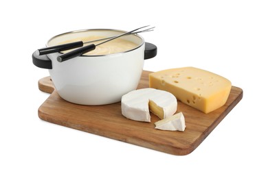 Photo of Fondue with tasty melted cheese, forks and pieces isolated on white