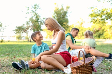 Happy family having picnic in park on sunny day