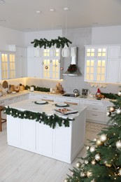 Cozy spacious kitchen decorated for Christmas. Interior design