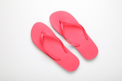 Photo of Stylish pink flip flops on white background, top view