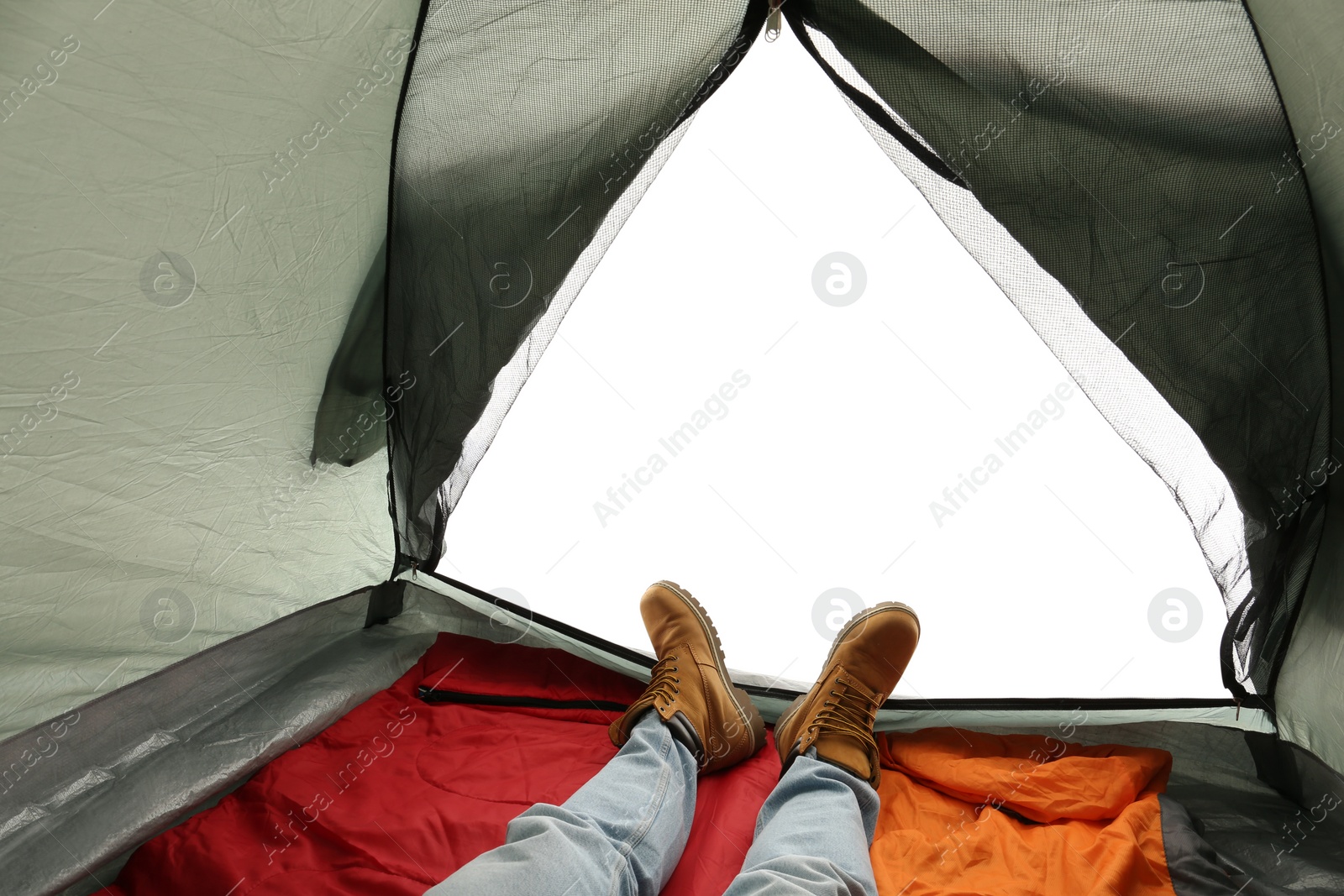 Photo of Closeup of man in camping tent on white background, view from inside