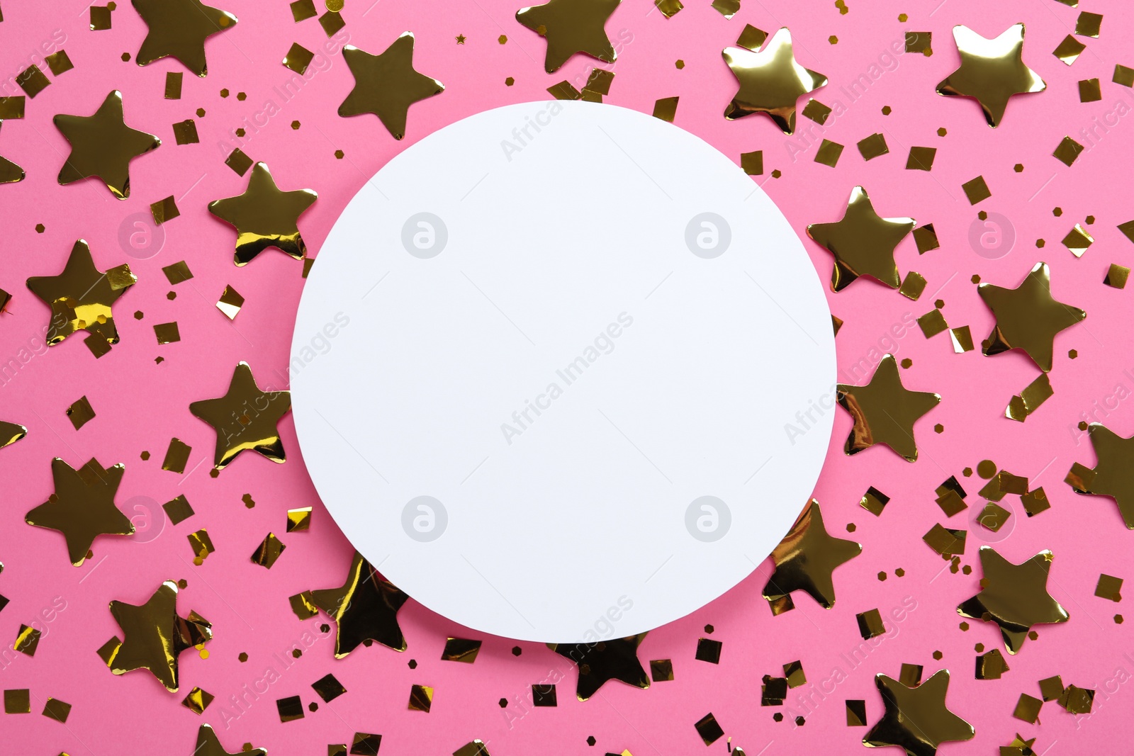 Photo of Blank card and shiny golden confetti on pink background, flat lay. Space for text