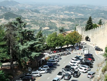 Photo of Aerial view of road with cars near castle on sunny day