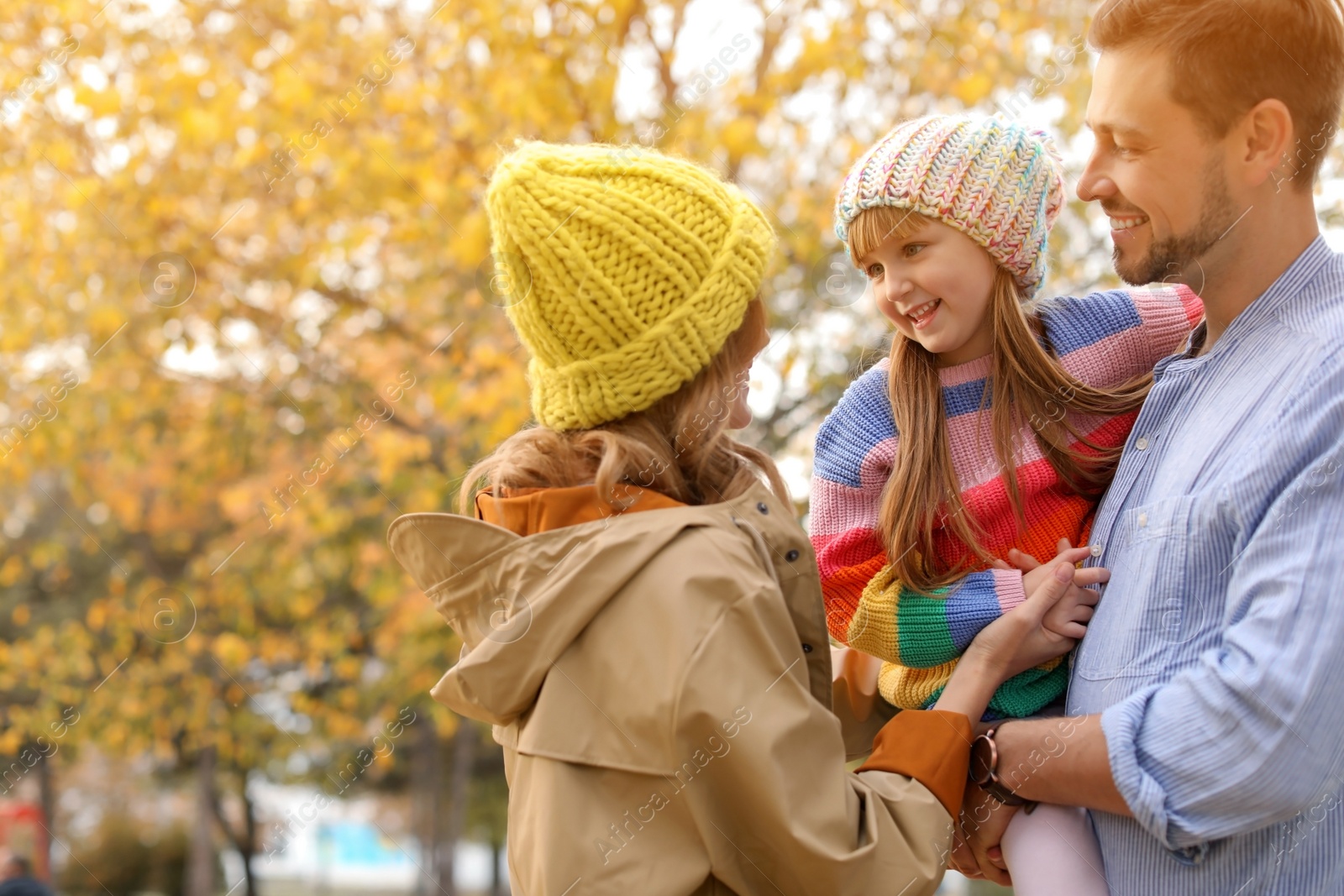 Photo of Happy family with child together in park. Autumn walk