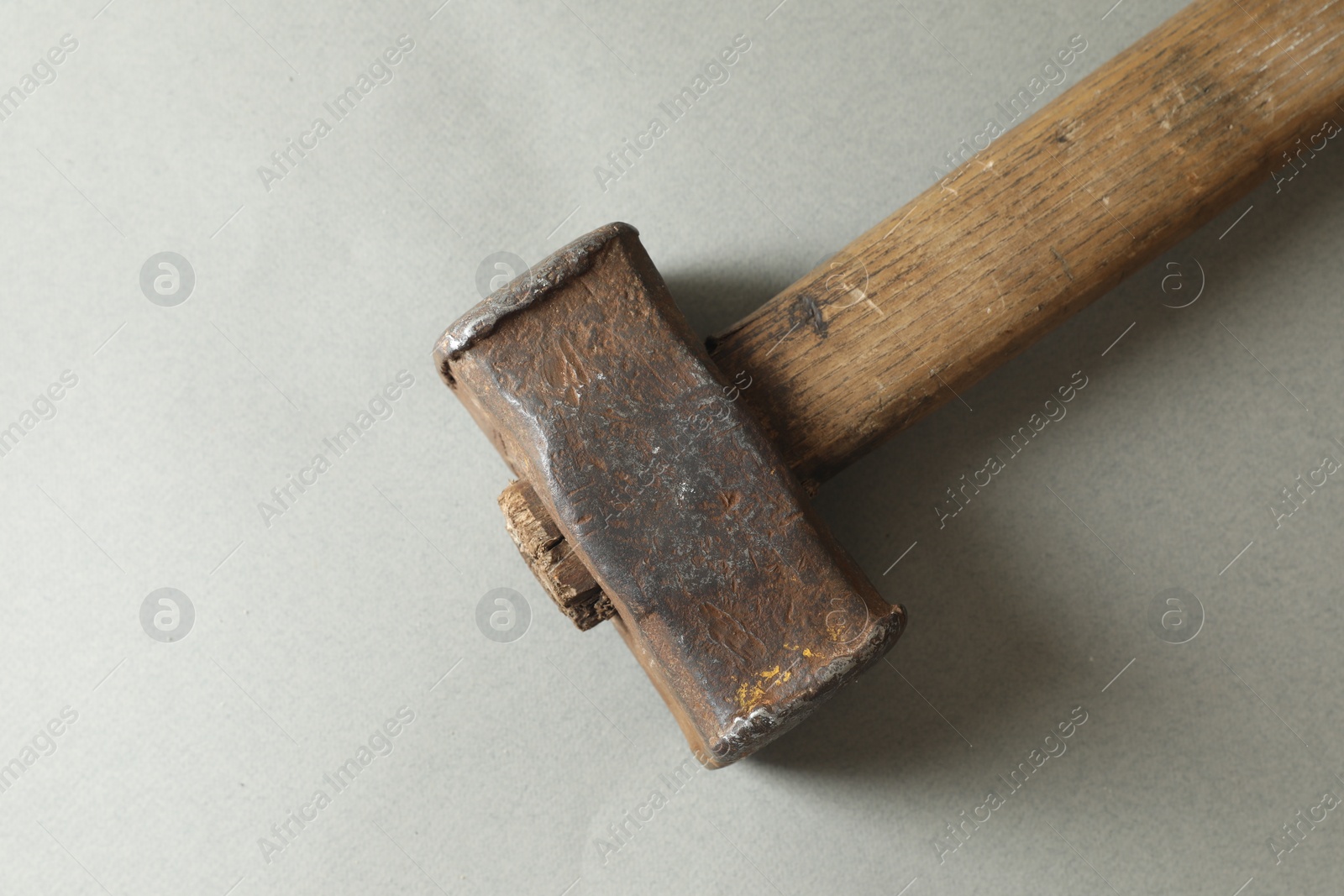 Photo of One sledgehammer on grey background, top view. Space for text