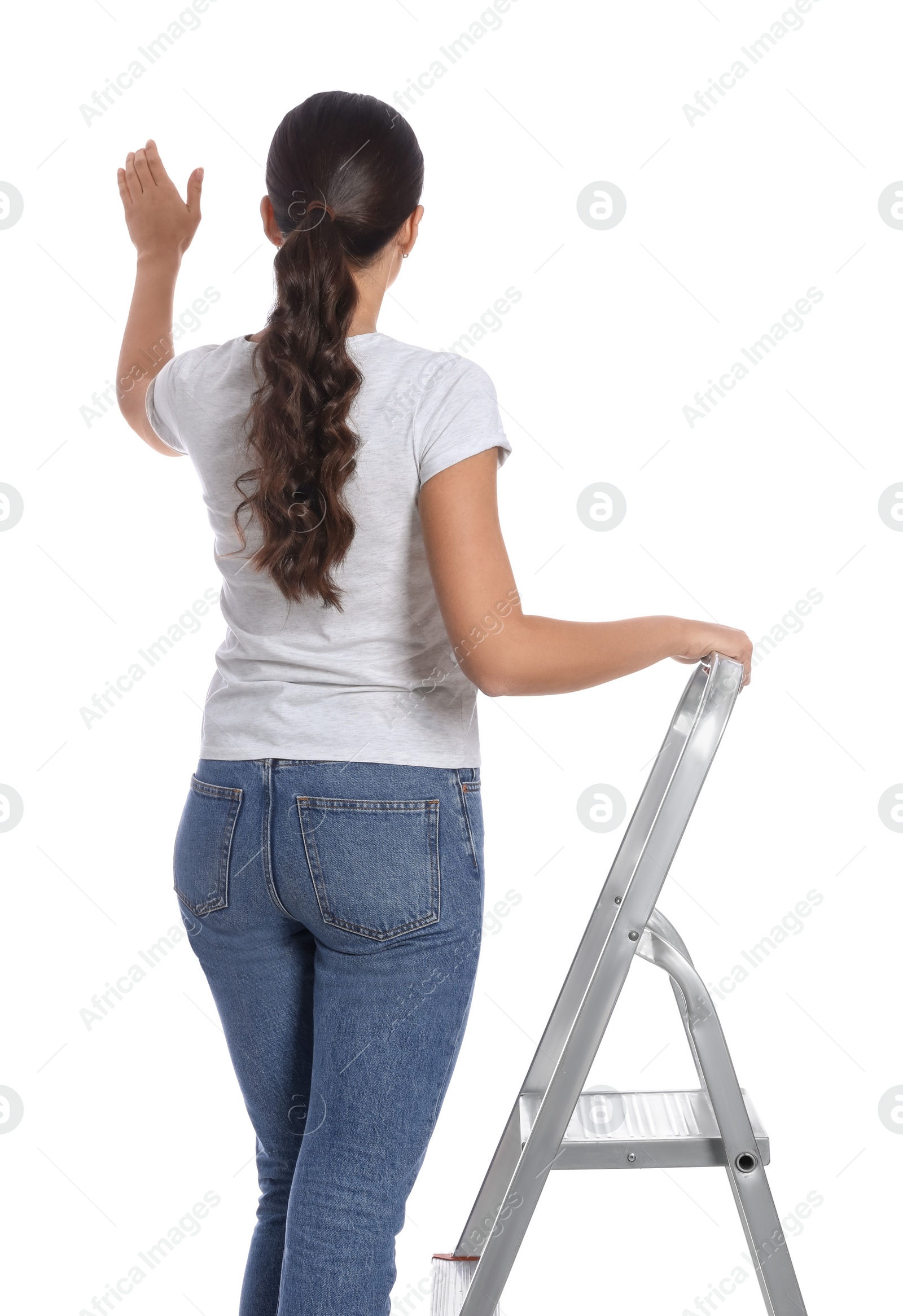 Photo of Young woman on metal ladder against white background, back view