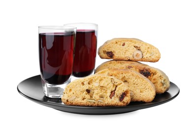 Photo of Plate with tasty cantucci and glasses of liqueur on white background. Traditional Italian almond biscuits