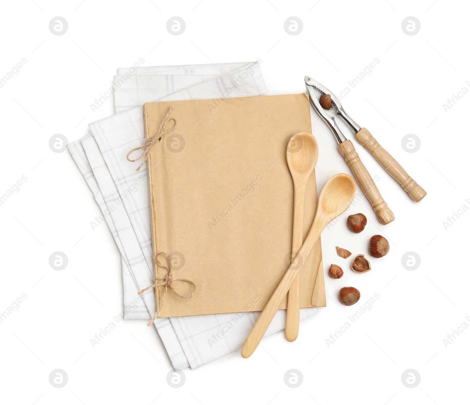 Photo of Blank recipe book, napkin, nuts and wooden utensils on white background, top view. Space for text