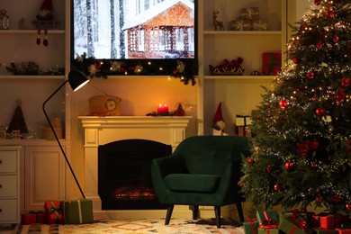 Living room interior with fireplace, armchair and Christmas decor