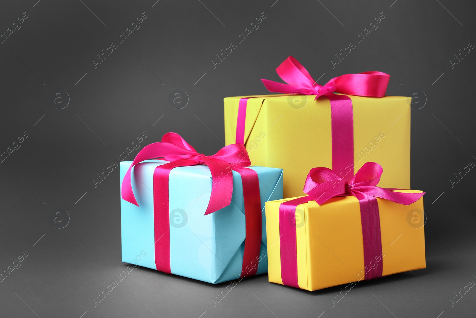 Photo of Beautiful gift boxes with ribbons on gray background