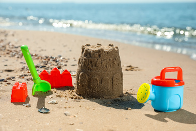 Different child plastic toys on sandy beach