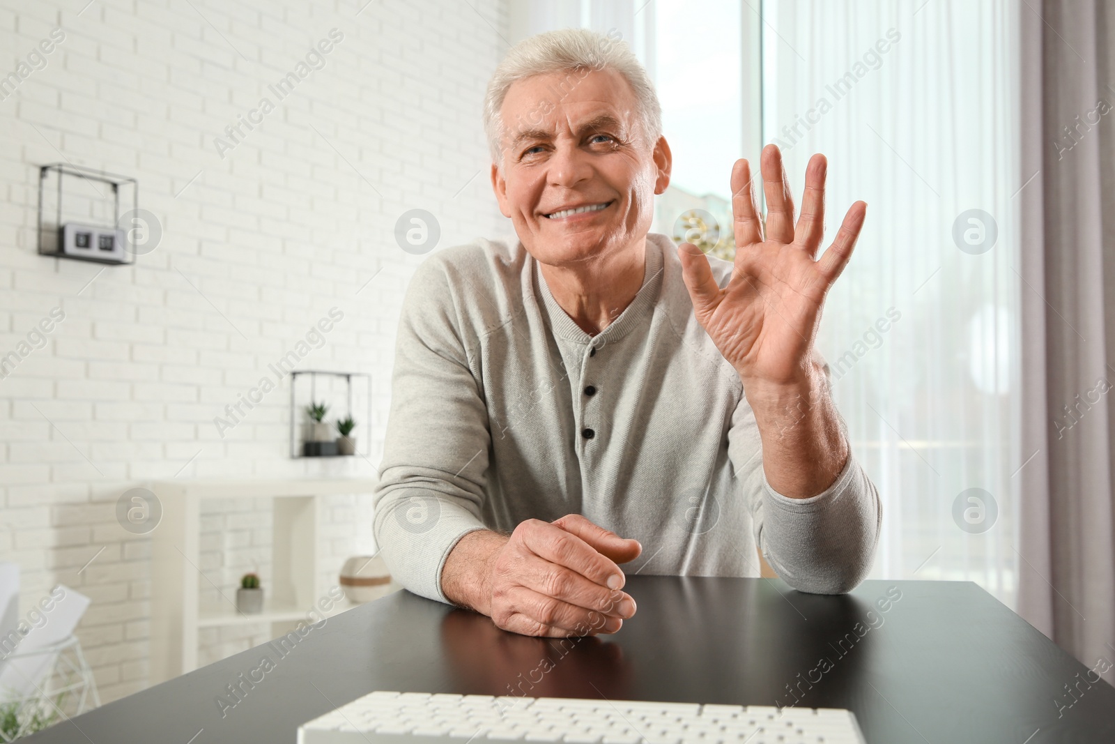 Photo of Mature man using video chat at home, view from web camera