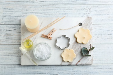 Photo of Flat lay composition with handmade candles on wooden background