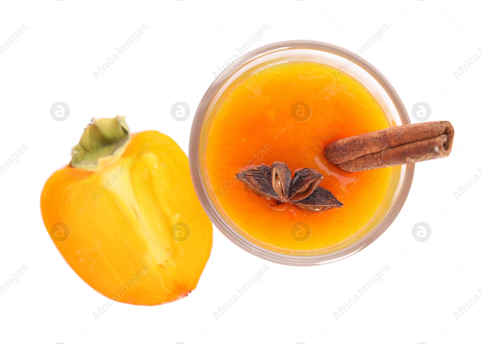 Photo of Tasty persimmon smoothie with anise and cinnamon isolated on white, top view