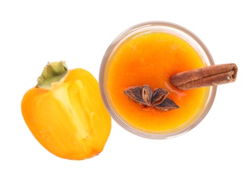 Photo of Tasty persimmon smoothie with anise and cinnamon isolated on white, top view