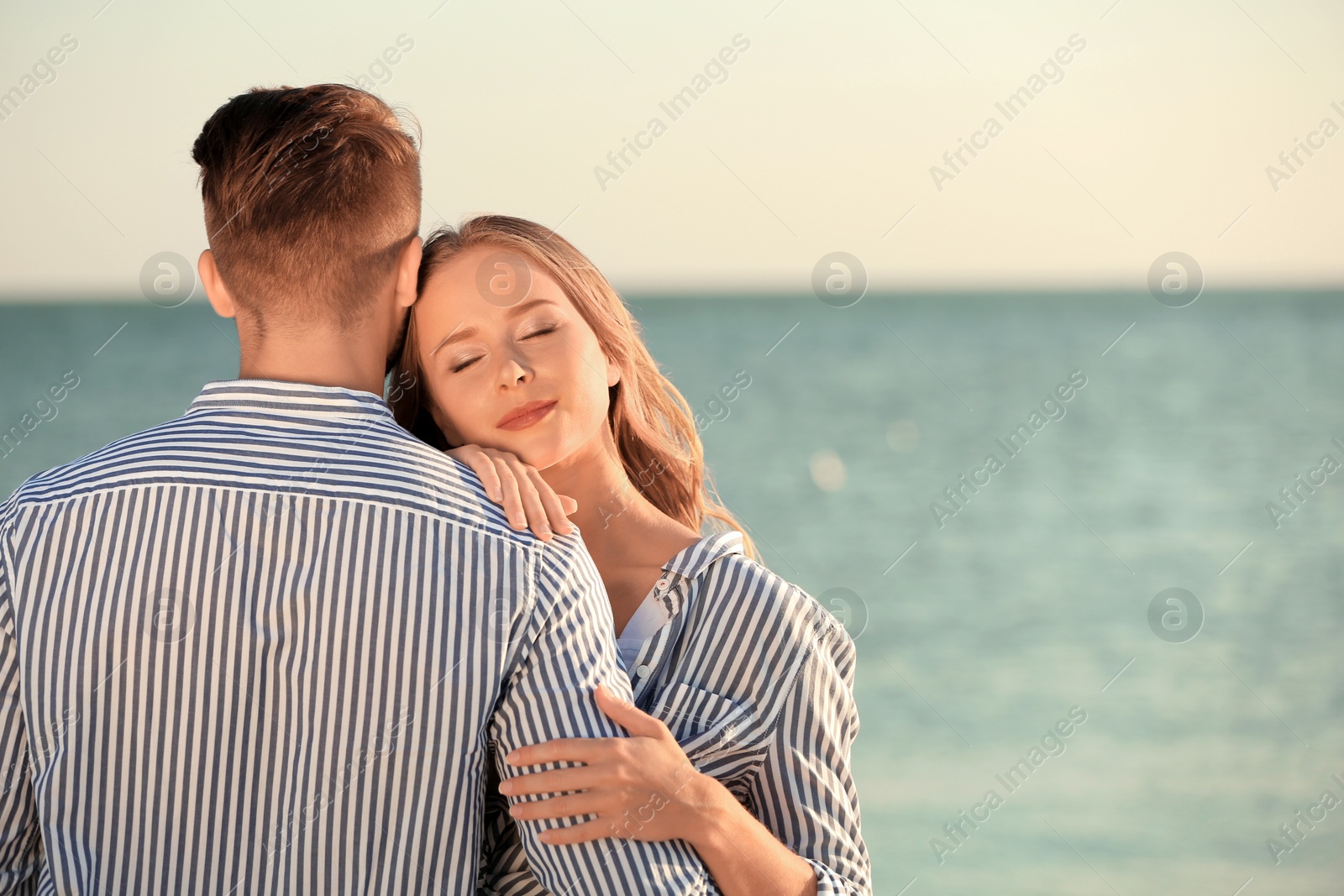 Photo of Happy young couple resting together on beach