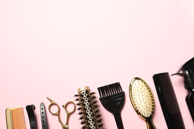 Photo of Professional hair dresser tools on pink background, flat lay. Space for text