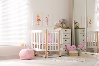 Photo of Baby room interior with beautiful pictures on wall