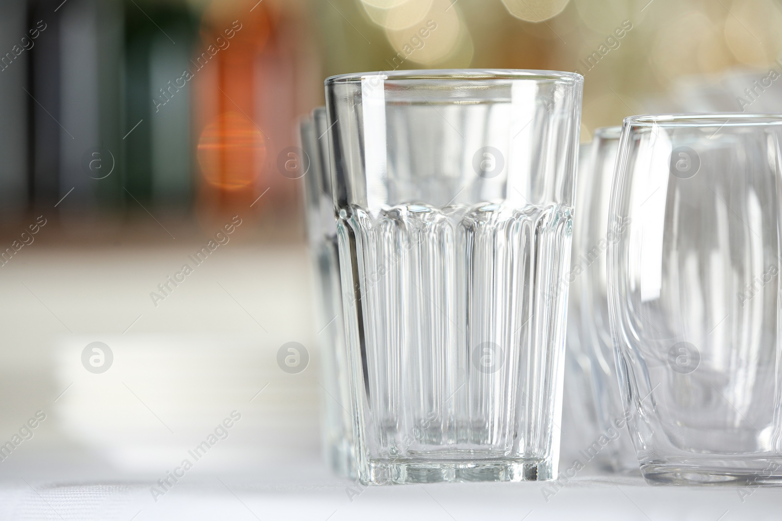 Photo of Set of empty glasses on table indoors