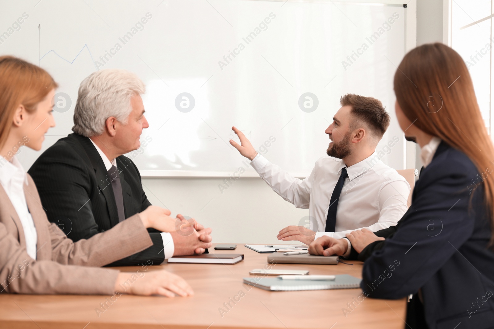 Photo of Professional business trainer working with people in office