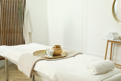 Photo of Stylish room interior with massage table in spa salon