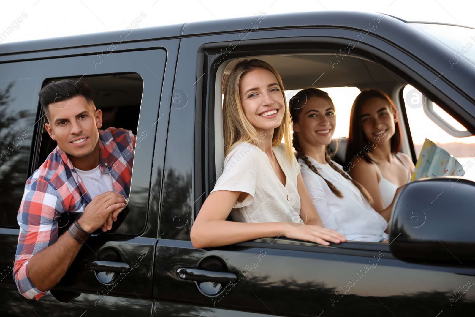 Photo of Happy friends together in car on road trip