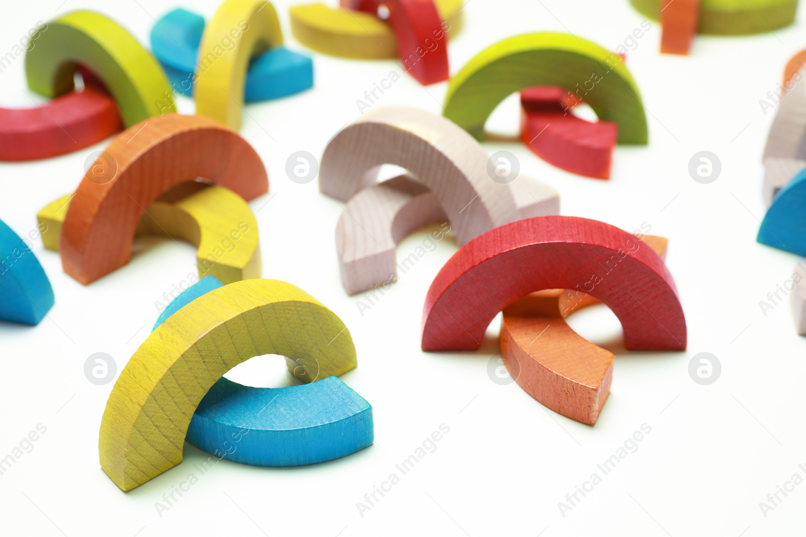 Photo of Colorful wooden pieces of play set isolated on white. Educational toy for motor skills development