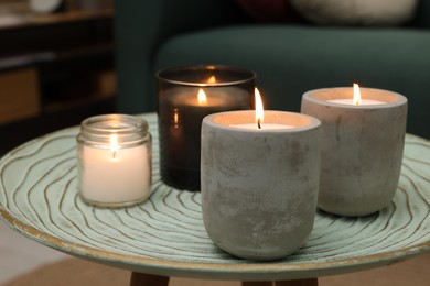 Lit candles on table in living room