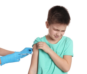 Doctor vaccinating little child on white background