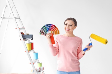 Photo of Young woman with color palette on white background