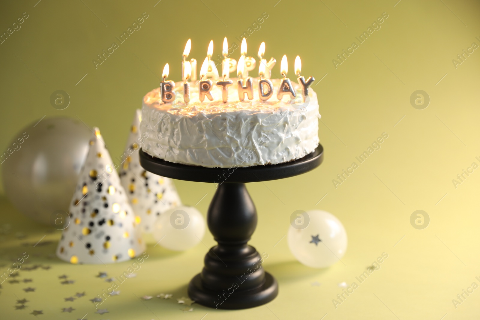 Photo of Tasty birthday cake with burning candles on green background, closeup