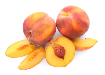 Photo of Whole and cut ripe peaches isolated on white, top view