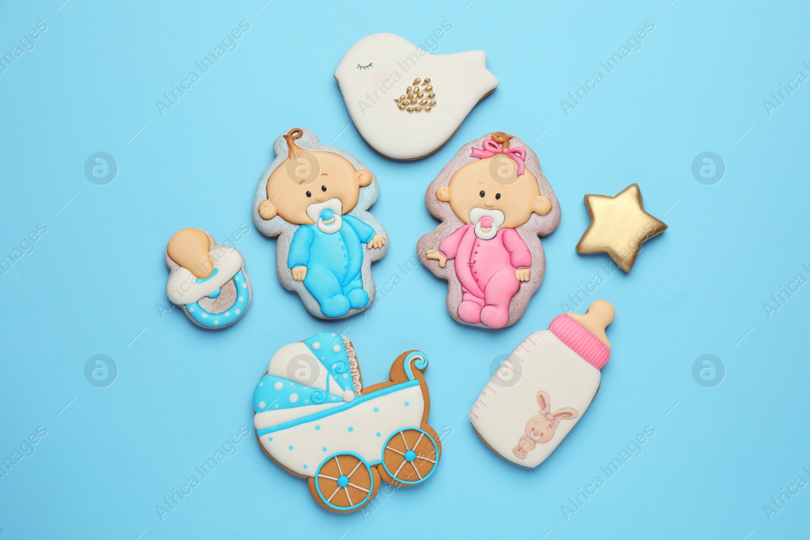 Photo of Set of baby shower cookies on turquoise background, flat lay