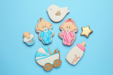 Set of baby shower cookies on turquoise background, flat lay