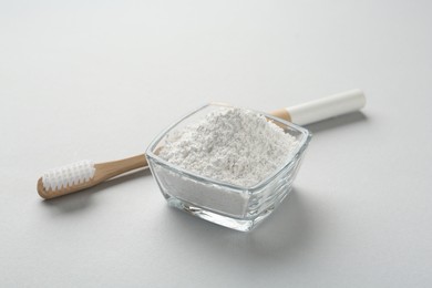 Tooth powder and brush on white background