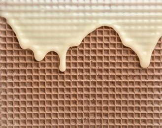 Photo of Hot white chocolate on wafer, closeup. Crispy food