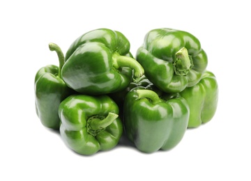 Pile of tasty green bell peppers on white background