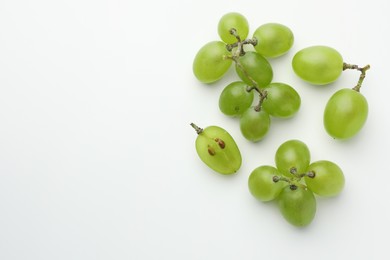 Photo of Fresh grapes on white background, top view. Space for text