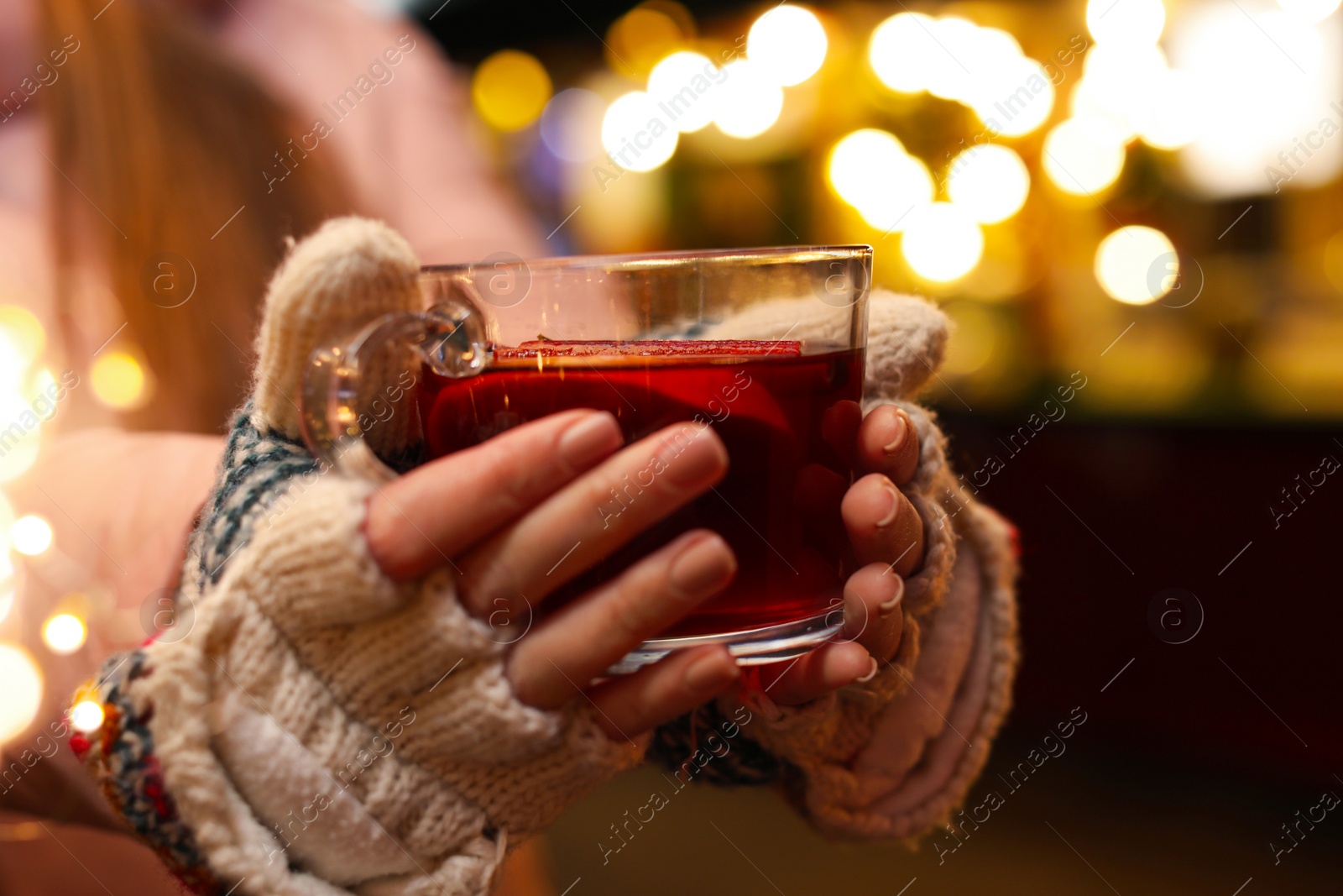 Photo of Woman with mulled wine at winter fair, closeup